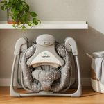 Folded Ingenuity Soothe ‘n Delight baby swing stored neatly in compact apartment corner for space efficiency