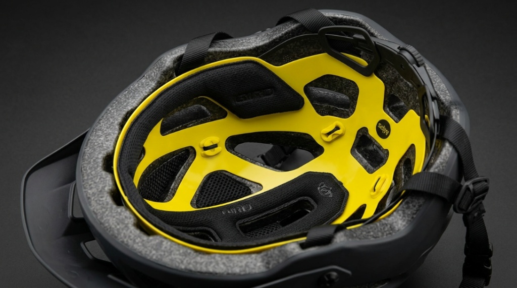 Close-up view of the yellow low-friction MIPS liner inside a cycling helmet.