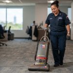 Janitor vacuuming a commercial Texas office floor.